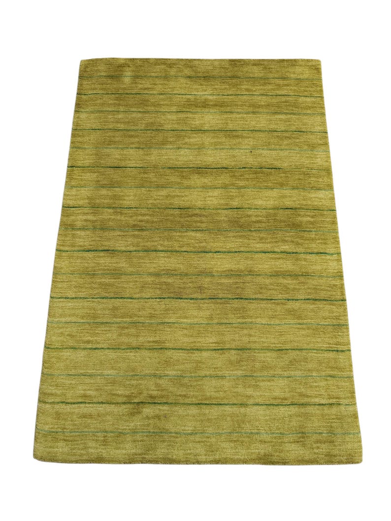 May include: A rectangular area rug featuring a textured, chartreuse green surface with a series of thin, horizontal dark green lines spaced evenly across the entire length of the piece, creating a subtle striped pattern on the flat pile.