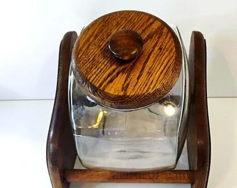 Vintage cookie jar in wooden base.