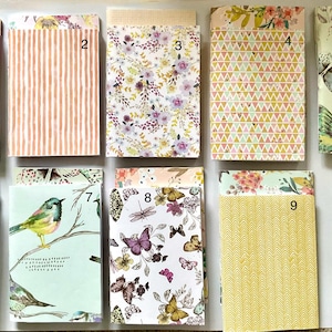 May include: Ten decorative paper envelopes with diverse designs. The envelopes feature floral, butterfly, and bird motifs in pastel colours. Some have striped or geometric patterns. Ideal for stationery or small gifts, these envelopes are a charming collection.