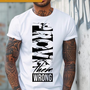 May include: A white t-shirt with a black graphic design that says "Prove them wrong" in a distressed font.