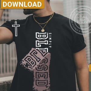 May include: Black t-shirt with the words "SIMPLY BLESSED" in white and a cross graphic. The word "BLESSED" is also printed in a distressed style on a rectangular shape. The shirt has a crew neck and short sleeves.