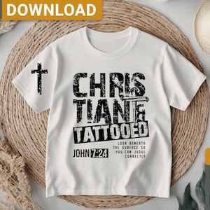 May include: White t-shirt with a black graphic design that says "Christian Tattooed" with a cross and the text "John 7:24" and "Look beneath the surface so you can judge correctly".