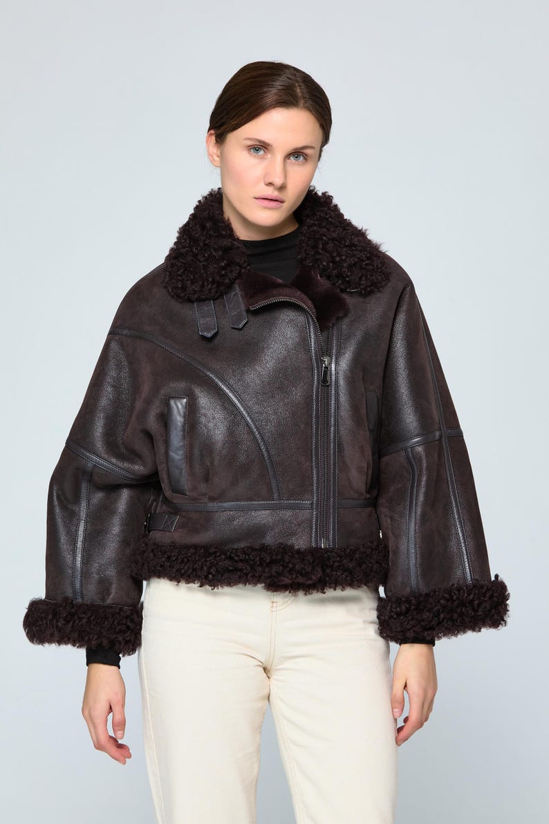 Woman wearing an authentic brown B3 shearling aviator jacket with thick natural sheepskin collar and custom fit design.