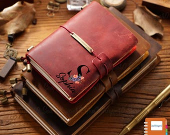 May include: A stack of three leather-bound journals with a red journal on top. The red journal has a personalized inscription that reads "Sophia" with a floral initial "S".