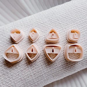 May include: A set of three ceramic mugs with a speckled, matte finish. The mugs are in shades of cream, light gray, and dark gray. Each mug has a simple, minimalist design, perfect for coffee or tea.