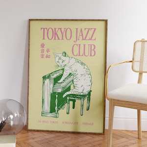 May include: A framed poster with a vintage aesthetic. The poster features a white cat playing a green piano, with the words "TOKYO JAZZ CLUB" in pink. Additional text includes Japanese characters and location details.