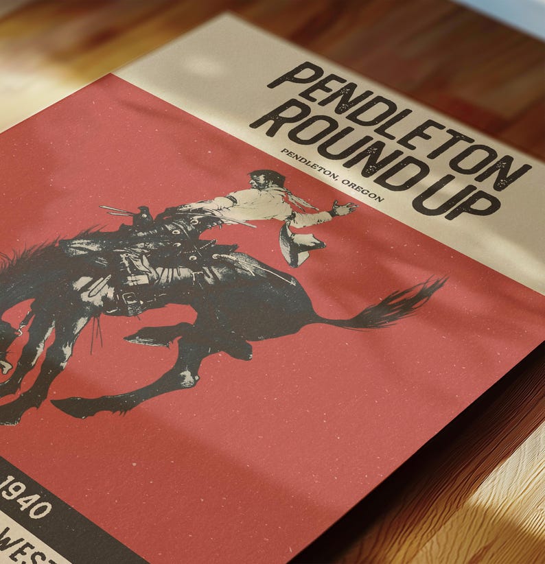 May include: A vintage poster with the text "PENDLETON ROUND UP" and "PENDLETON, OREGON." The poster features a black and white illustration of a cowboy riding a bucking bronco against a red background. The year "1940" is also visible.