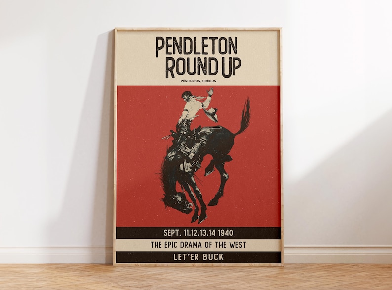 May include: Framed vintage poster for the Pendleton Round Up rodeo event. The poster features a cowboy riding a bucking bronco against a red background. Text includes "Pendleton Round Up" and event details.