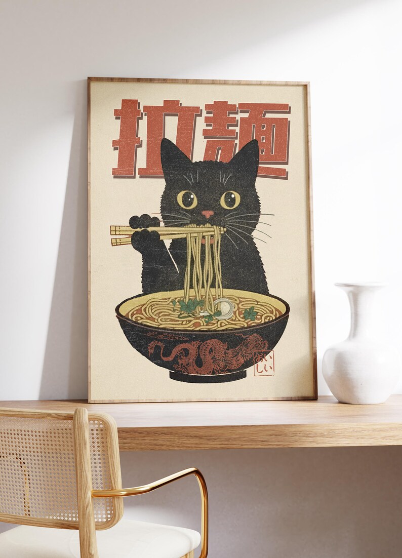 May include: A vintage-style poster featuring a black cat eating ramen noodles with chopsticks. The poster has a red background with Japanese characters that say "Ramen Cat".