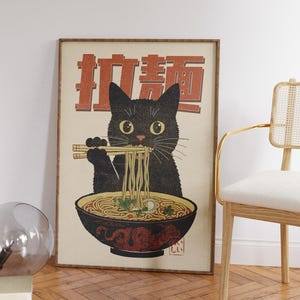May include: A vintage-style poster featuring a black cat eating ramen noodles with chopsticks. The poster has the Japanese text "Ramen" in red and white lettering.