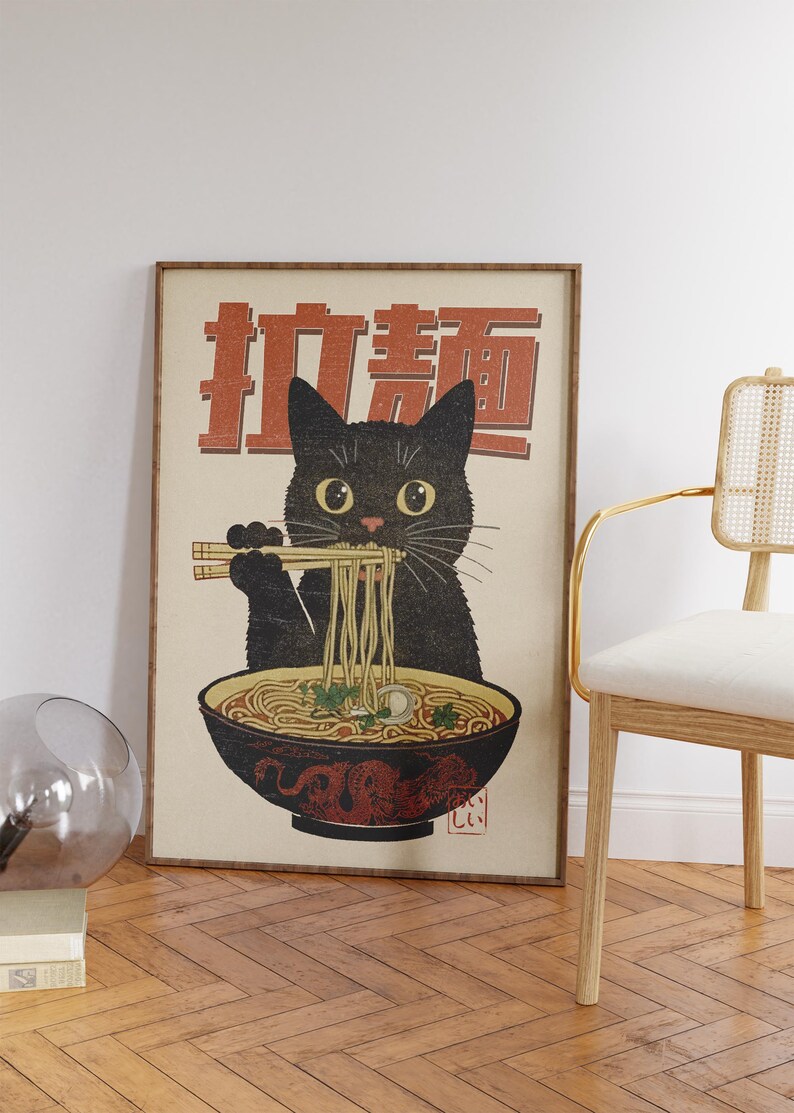 May include: A vintage-style poster featuring a black cat eating ramen noodles with chopsticks. The poster has the Japanese text "Ramen" in red and white lettering.