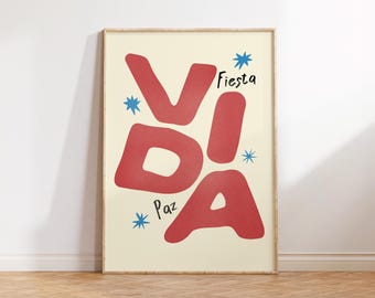 May include: A framed art print with the word "VIDA" in large red letters, with the words "Fiesta" and "Paz" in black. Blue star shapes are scattered around the text on a cream background.