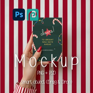 May include: A mockup image featuring a dark green card with the text "cheers!" and "To Bright New Days Ahead." The card is decorated with candy canes and string lights. The word "Mockup" is displayed in large white letters. The background is red and white stripes.