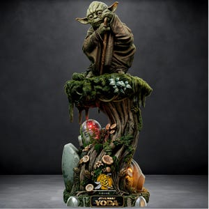 May include: A detailed statue of Yoda from Star Wars, seated atop a tree-like structure with R2-D2. The statue is predominantly green and brown, with a detailed base featuring mushrooms and foliage. The base has the words "FIGURE" and "STAR WARS YODA".