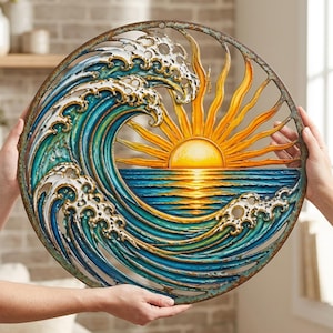 May include: A circular metal wall art piece featuring a stylized ocean wave in shades of blue and teal with white foam crests. The design includes a bright yellow and orange sun rising over the horizon, with rays extending to the outer frame.