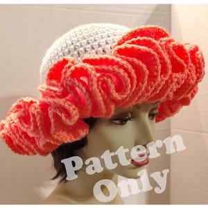 May include: A white crochet hat with a large, bright orange ruffle around the brim. The hat is on a mannequin head. The text "Pattern Only" is superimposed on the image.