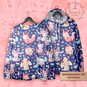 Könnte beinhalten: Ein marineblaues Sweatshirt- und Hoodie-Set mit einem sich wiederholenden Muster aus Cartoon-Charakteren in Rosa, Weiß und Blau. Das Sweatshirt hat einen Rundhalsausschnitt und der Hoodie eine Kapuze mit Kordelzug. Der Text "OK!" ist sichtbar.