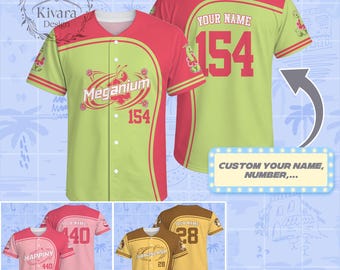 May include: A button-down baseball jersey in lime green and pink featuring the text Meganium and the number 154 on the front, with a customizable name and number on the back. Additional examples show pink and brown color variations with character names.