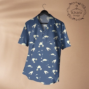 May include: A short-sleeved button-down shirt in a deep blue colour featuring an all-over repeating pattern of small, cream-coloured cartoon creatures. The shirt has a classic collar and is displayed on a black hanger with the Kivara Design logo.