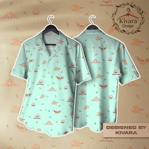 May include: A light teal button-up shirt with a repeating pattern of cartoon owls and other shapes. The shirt is displayed on a hanger, showing both the front and back. The text "Designed by KIVARA" is visible.
