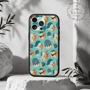 May include: A black phone case featuring a repeating pattern on a light blue background. The design includes small cartoon creatures with cream-coloured bodies, blue heads, and red flame-like spikes, interspersed with blue and cream-coloured oval eggs.