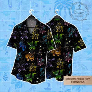 May include: A black short-sleeved button-down shirt featuring a repeating pattern of various glowing, colorful creature silhouettes against a starry background. The design includes yellow, green, blue, and purple figures. Text reads Designed by Kivara.
