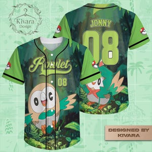 May include: A green baseball jersey featuring a Rowlet character graphic on the front with the text Rowlet and 08. The back displays the name JONNY and the number 08. The design includes a forest background, black trim, and Poké Ball sleeve accents.