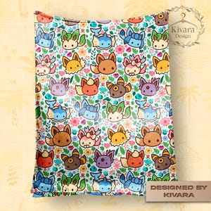 May include: A white blanket featuring a repeating pattern of cartoon-style creatures and flowers in various colors. The creatures have different colors and expressions. The blanket has a floral background with the text "Designed by KIVARA".