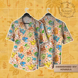 May include: A short-sleeved button-down shirt featuring a repeating pattern of colorful cartoon characters on a light peach background. The shirt is displayed on a black hanger. The words "Designed by KIVARA" are visible.