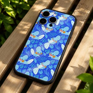 May include: A smartphone case featuring a repeating pattern of light blue aquatic creatures with orange cheeks, white fins, and tails, set against a dark blue background with seaweed, coral, and starfish motifs. The case has a black border.