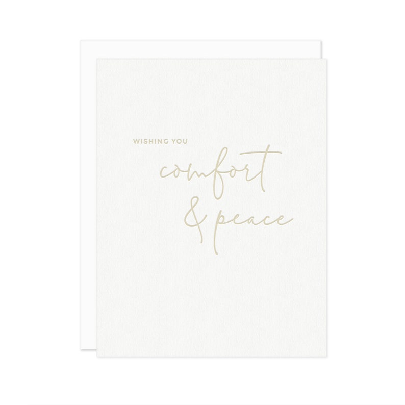 May include: A white card with the text "Wishing you comfort & peace" in a light brown font.