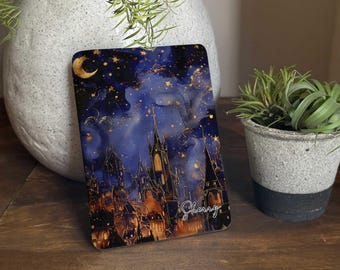 May include: A rectangular, decorative item featuring a night sky design with a crescent moon, stars, and a castle silhouette. The artwork is in shades of blue, gold, and orange, with the name "Sherry" in cursive script.