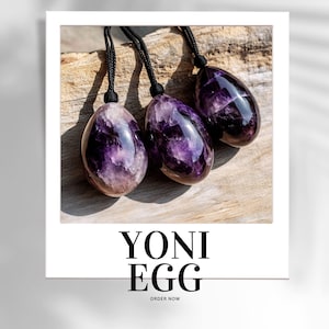 May include: Three purple amethyst yoni eggs with black cords hanging from them. The eggs are on a wooden surface. The text "YONI EGG" and "ORDER NOW" is below the image.