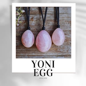 May include: Three pink rose quartz yoni eggs hanging from black cords. The eggs are smooth and polished, with a natural, translucent appearance. The text "YONI EGG" is displayed in a bold, black font below the eggs, with "ORDER NOW" beneath.