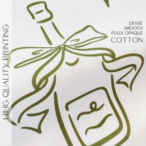 May include: A white background featuring a green outline of a champagne bottle with a bow. The text "HIHG QUALITY PRINTING" is on the left. The text "DENSE SMOOTH FULLY OPAQUE COTTON" is on the right.