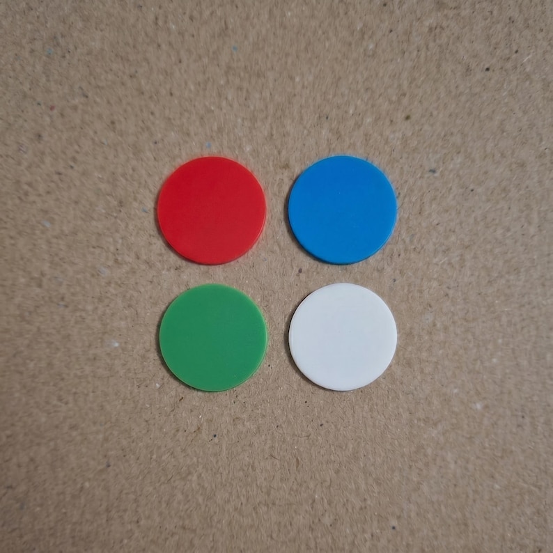 May include: Four colorful, circular game pieces. The pieces are red, blue, green, and white. The pieces are arranged in a square pattern against a neutral background.