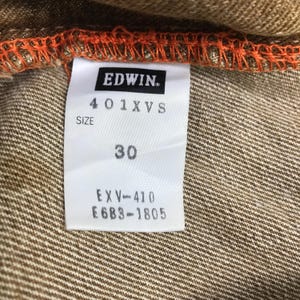 May include: A white tag with black text that reads "EDWIN", "401XVS", "SIZE 30", "EXV-410", and "E6B3-1805".