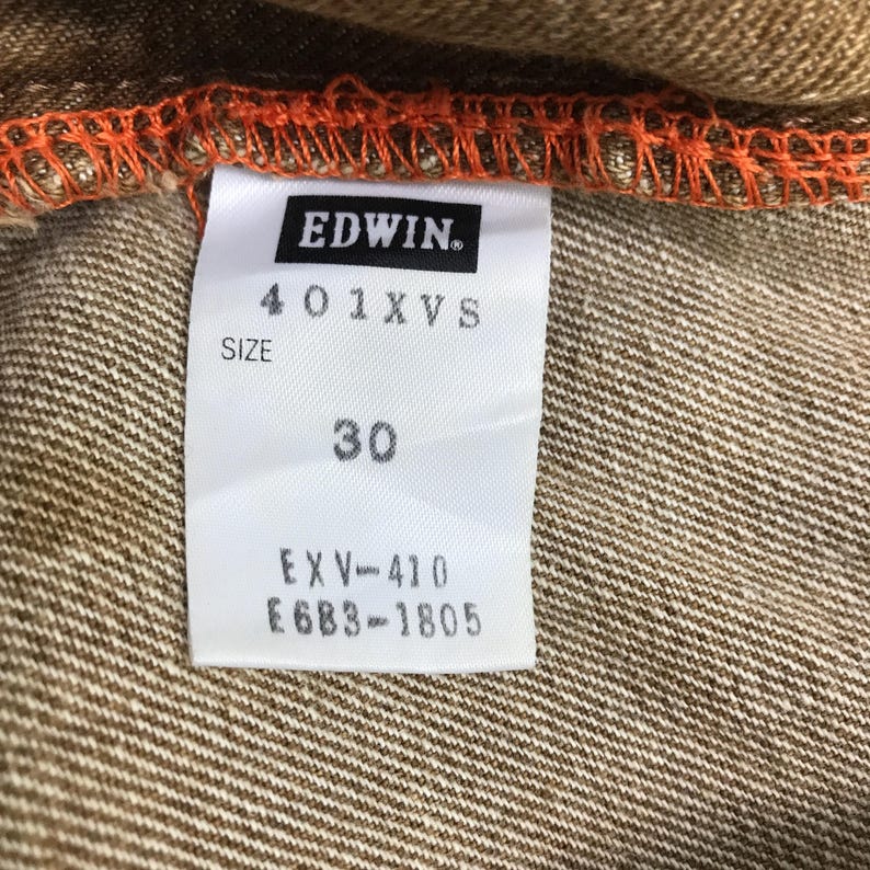 May include: A white tag with black text that reads "EDWIN", "401XVS", "SIZE 30", "EXV-410", and "E6B3-1805".