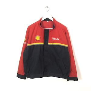 May include: Red, black, and yellow Shell Helix jacket. The jacket has a stand-up collar and a full-length zipper. The Shell logo is on the chest, and the Helix logo is on the right side. The jacket has a black bottom half and red top half.