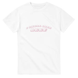 May include: White t-shirt with the text "I smell like beef" in pink letters.