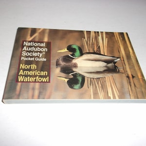 May include: A pocket guide from the National Audubon Society featuring a mallard duck on the cover. The book is titled "North American Waterfowl" and shows a detailed illustration of the duck in a natural habitat.