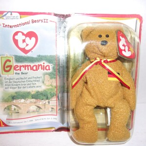 May include: A set of three ceramic mugs with a speckled, matte finish. The mugs are in shades of cream, light gray, and dark gray. Each mug has a simple, minimalist design and a rounded handle.