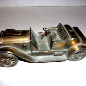 May include: A set of three ceramic mugs with a speckled, matte finish. The mugs are in shades of cream, light gray, and dark gray. Each mug has a simple, minimalist design and a rounded handle. The mugs are likely for coffee or tea.