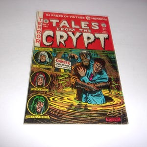 May include: A vintage Tales from the Crypt comic book featuring a red cover with a swamp scene. A monster pulls a person into yellow quicksand near a sign that reads DANGER QUICKSAND KEEP AWAY. Three circular character portraits are on the left side.
