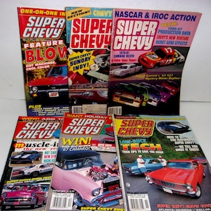 May include: A collection of vintage "Super Chevy" magazines. The covers feature vibrant colors, classic car illustrations, and text such as "Muscle-in", "Win!", and "Low-Buck Tech". The magazines showcase automotive content.