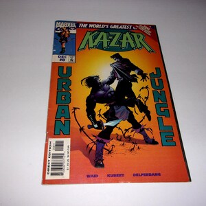 May include: A Marvel Comics Ka-Zar issue number 8 comic book from December. The cover features a yellow and orange background with the title Urban Jungle in large teal letters. Two figures are depicted in a combat pose with a knife.