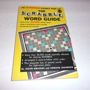 May include: A vintage "Scrabble Word Guide" book with a yellow cover. The book features the title in large letters, along with the text "The Authorized Scrabble Word List." The cover also displays a Scrabble board graphic and text about the book's contents.