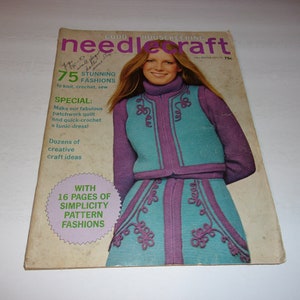 May include: Vintage "Good Housekeeping needlecraft" magazine cover. The cover features a woman wearing a teal and purple knitted outfit. Text includes "75 Stunning Fashions" and "16 Pages of Simplicity Pattern Fashions".