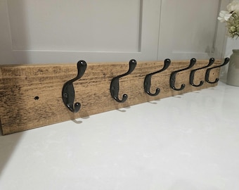 A handmade versatile rustic coat rack with hooks.