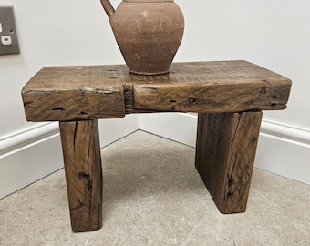 A vintage rustic bench crafted from aged reclaimed beams
